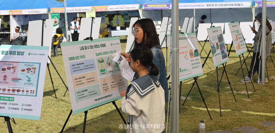 ‘제1회 대한민국 저탄소식생할 문화축제 및 실천대회’를 찾은 아이들이 홍보 패널을 살펴보고 있다.